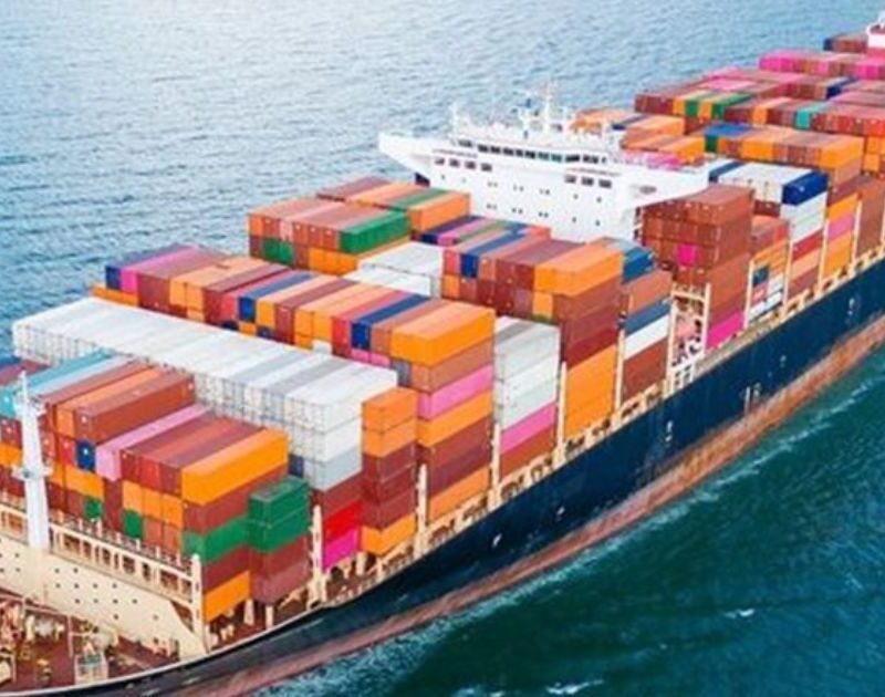 Aerial view of a large cargo container ship transporting goods across the open ocean